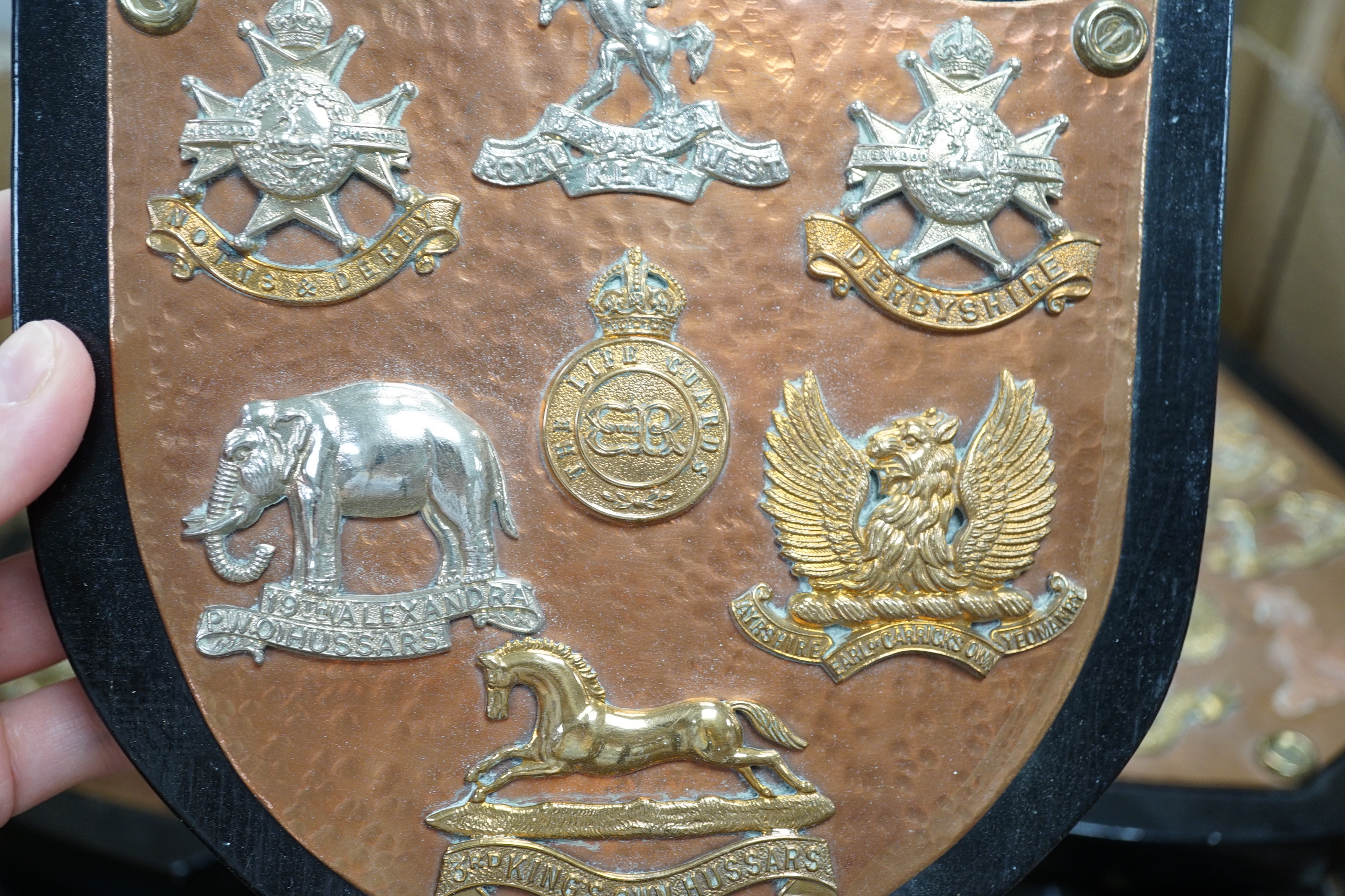 A collection of Military cap badges and buttons